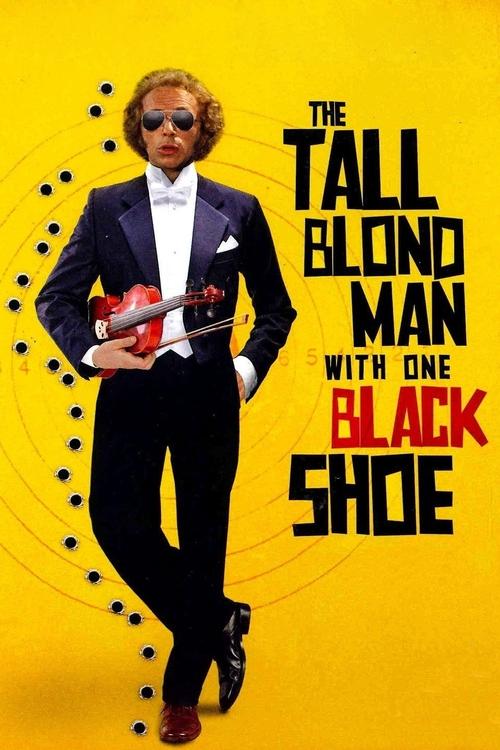 The poster features a tall blond man in a sharp black suit holding a red guitar, standing confidently against a vibrant yellow background. The bold typography and dynamic pose convey a sense of charisma and energy. The overall mood is playful and energetic, suggesting a fun and engaging musical e...