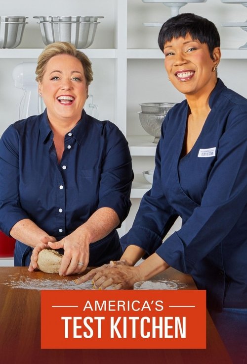Two women in navy uniforms stand behind a wooden counter, smiling warmly at the camera. The warm lighting and inviting atmosphere suggest a friendly, approachable cooking show. The vibrant red banner at the bottom reinforces the show's identity.