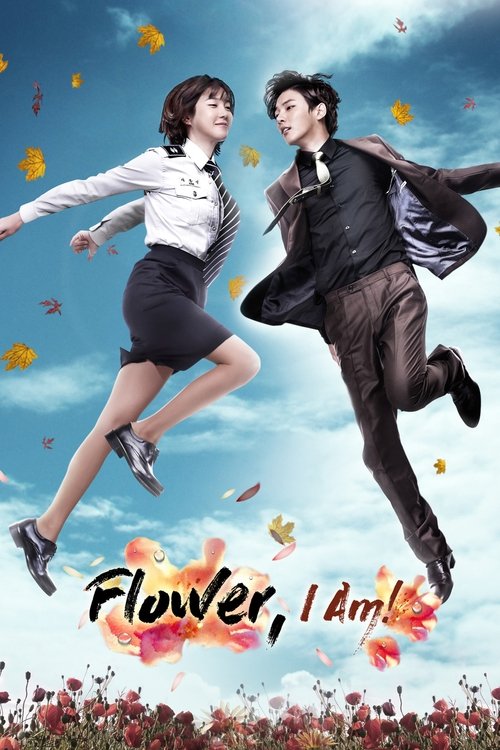 The poster features two characters in mid-air against a vibrant blue sky, with autumn leaves scattered around. The man in a sharp black suit and the woman in a white blouse and black skirt exude energy and joy. The title "Flower, I Am!" is prominently displayed in bold, fiery orange letters at th...