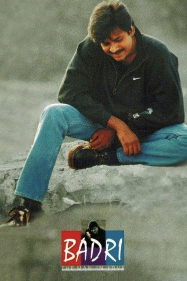A man in a black jacket and blue jeans sits on a snowy hill, looking down with a contemplative expression. The poster features the title "BADRI" in bold red letters at the bottom, evoking a sense of mystery and introspection.