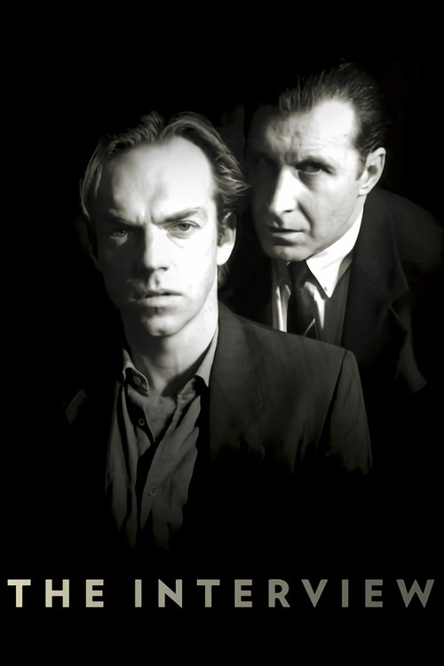 The black-and-white poster features two men in formal attire against a stark black background. The mood is mysterious and dramatic, with a sense of intrigue conveyed through their serious expressions and the film's title, "The Interview," prominently displayed at the bottom.