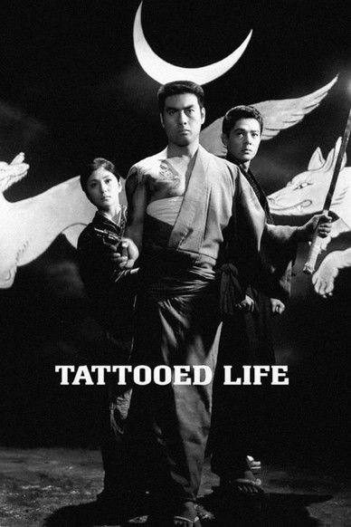 The poster features three men in a moody, atmospheric scene with a crescent moon and flag in the background. The black-and-white aesthetic evokes a gritty, dramatic mood, while the bold text "TATTOOED LIFE" anchors the image.