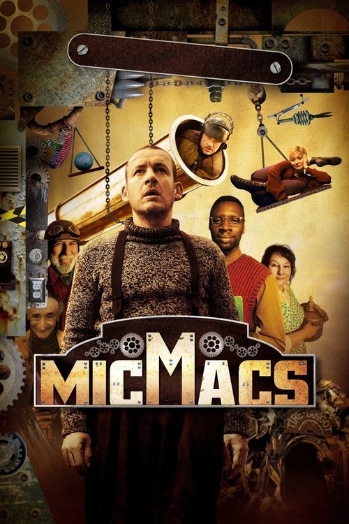 The poster features a central figure in a dark, textured outfit with a prominent "MICMACS" title. Surrounding him are six diverse characters, each holding tools or objects, suggesting a work environment. The warm, earthy tones and rustic background evoke a gritty, adventurous atmosphere.
