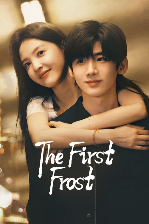 The image features two young people embracing warmly in a cozy, dimly lit setting. The warm tones and soft lighting create a comforting atmosphere, while the title "The First Frost" is elegantly displayed in white text.
