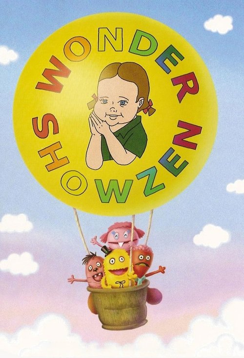 This vibrant poster features a cheerful yellow balloon with "WONDER SHOWZEN" written in colorful letters, accompanied by a smiling girl peeking through the rim. Three children joyfully ride in a basket, exuding happiness and wonder against a bright blue sky with fluffy white clouds. The overall m...